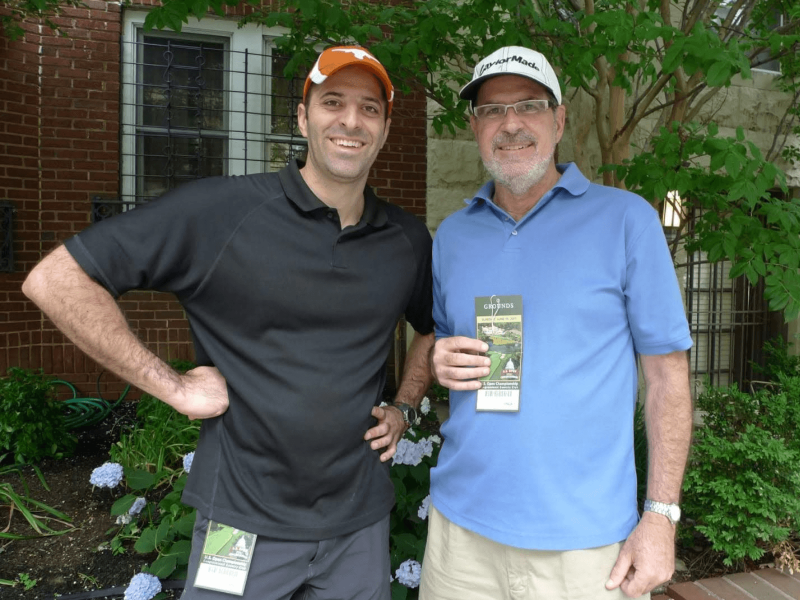 Sean Murphy and his father smiling together, holding tickets to the 2011 U.S. Open.